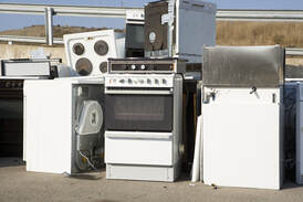 Picture of all kinds of appliances stacked up including dishwashers, washer, dryers, stoves, etc.