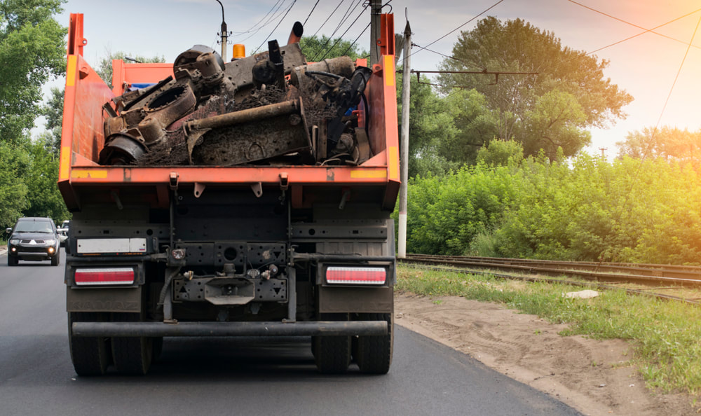 Picture of a dump-truck hauling away trash. 